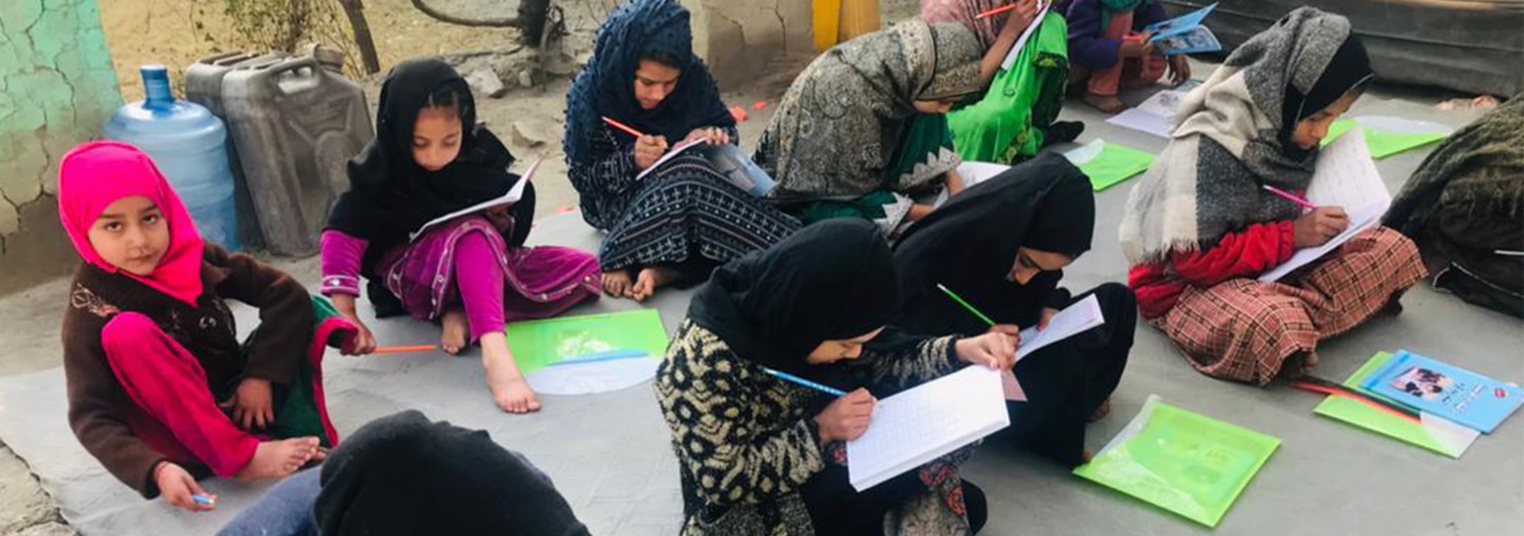 Girls writing and studying in an AWAKEN education program