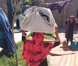 Woman with a sewing machine from AWAKEN vocational training